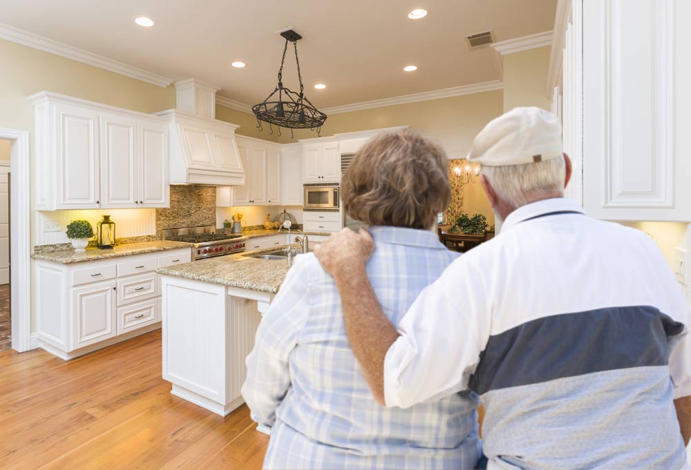 Senior Couple looking at kitchen, getting ready to sell their home